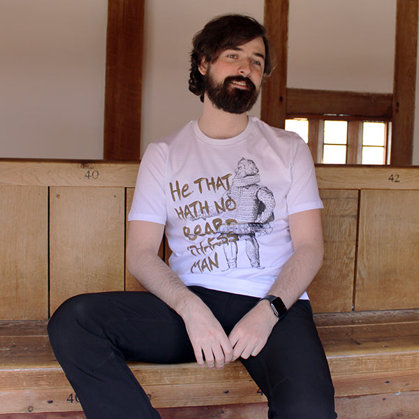 White t-shirt with gold graphic text and black and white historical image of man with a beard