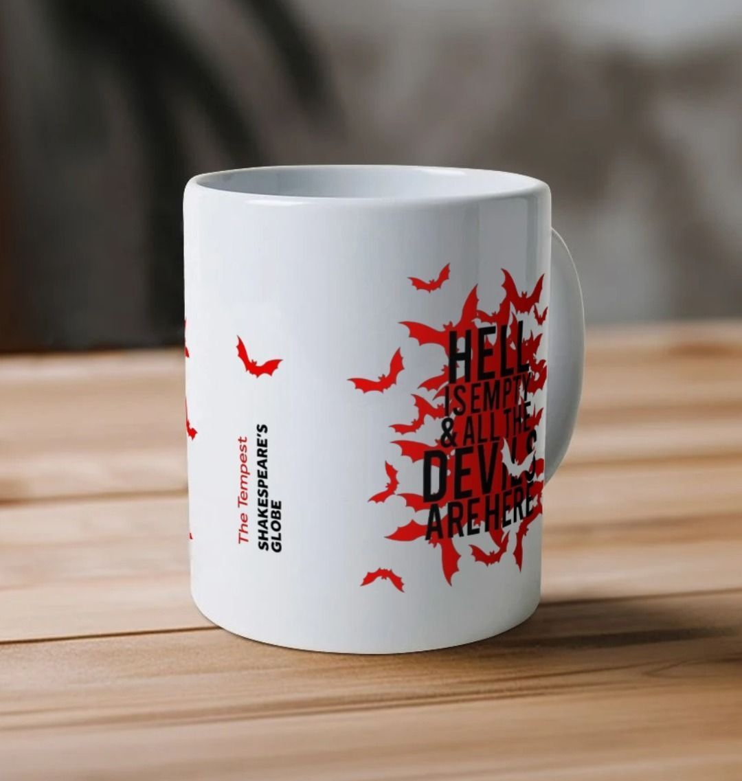 White mug with red bats graphic on either side, with black text overtop