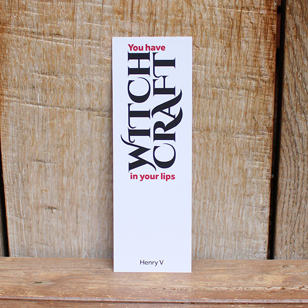 white card bookmark with black text on a wooden background