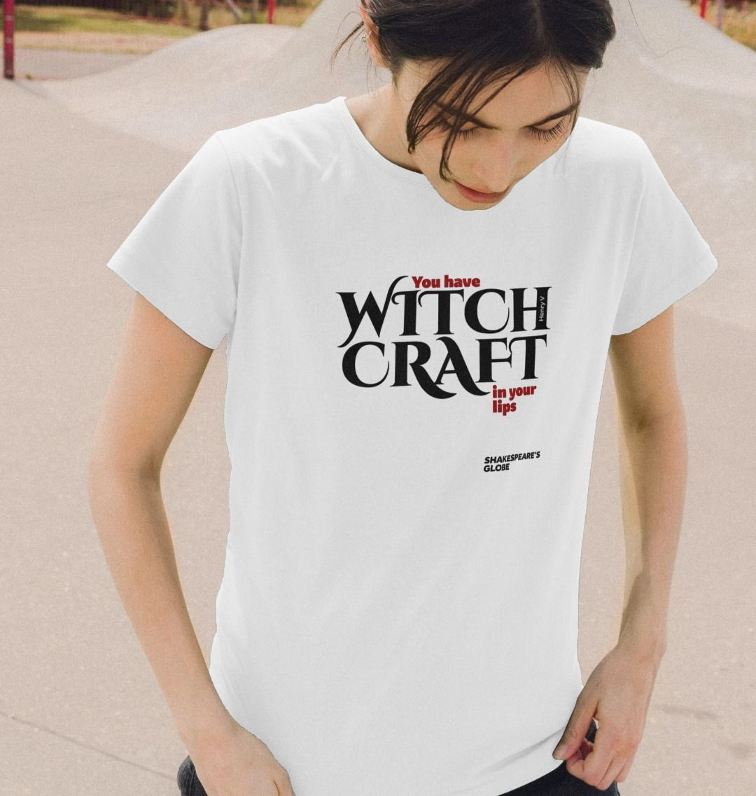 Person wearing a white t-shirt with text 'You have WITCH CRAFT in your lips' on a neutral background