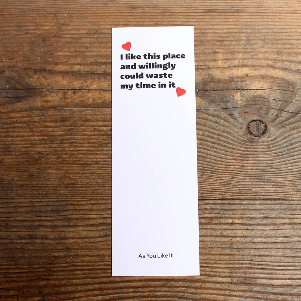 White bookmark with bold black text and red hearts