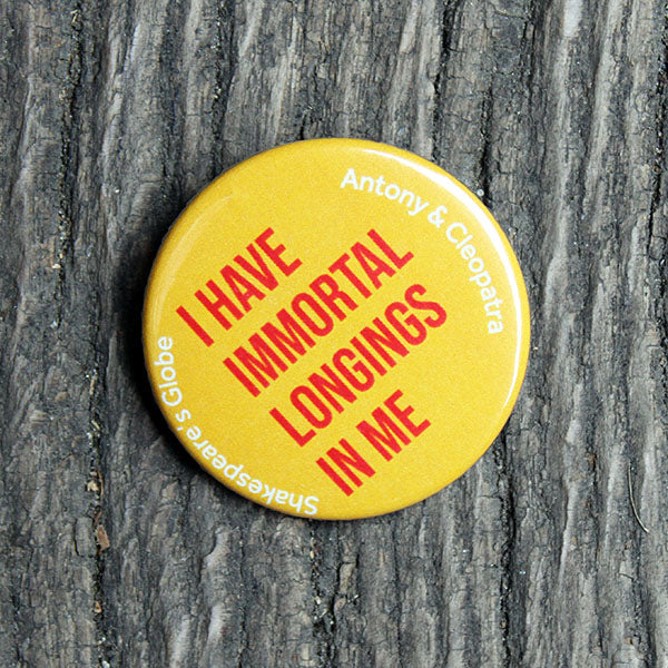 bright yellow button badge with red text