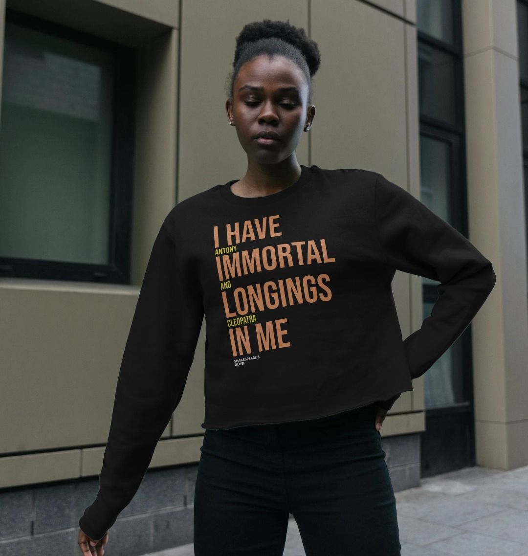 Black boxy sweatshirt with orange and yellow graphic text print on the centre front