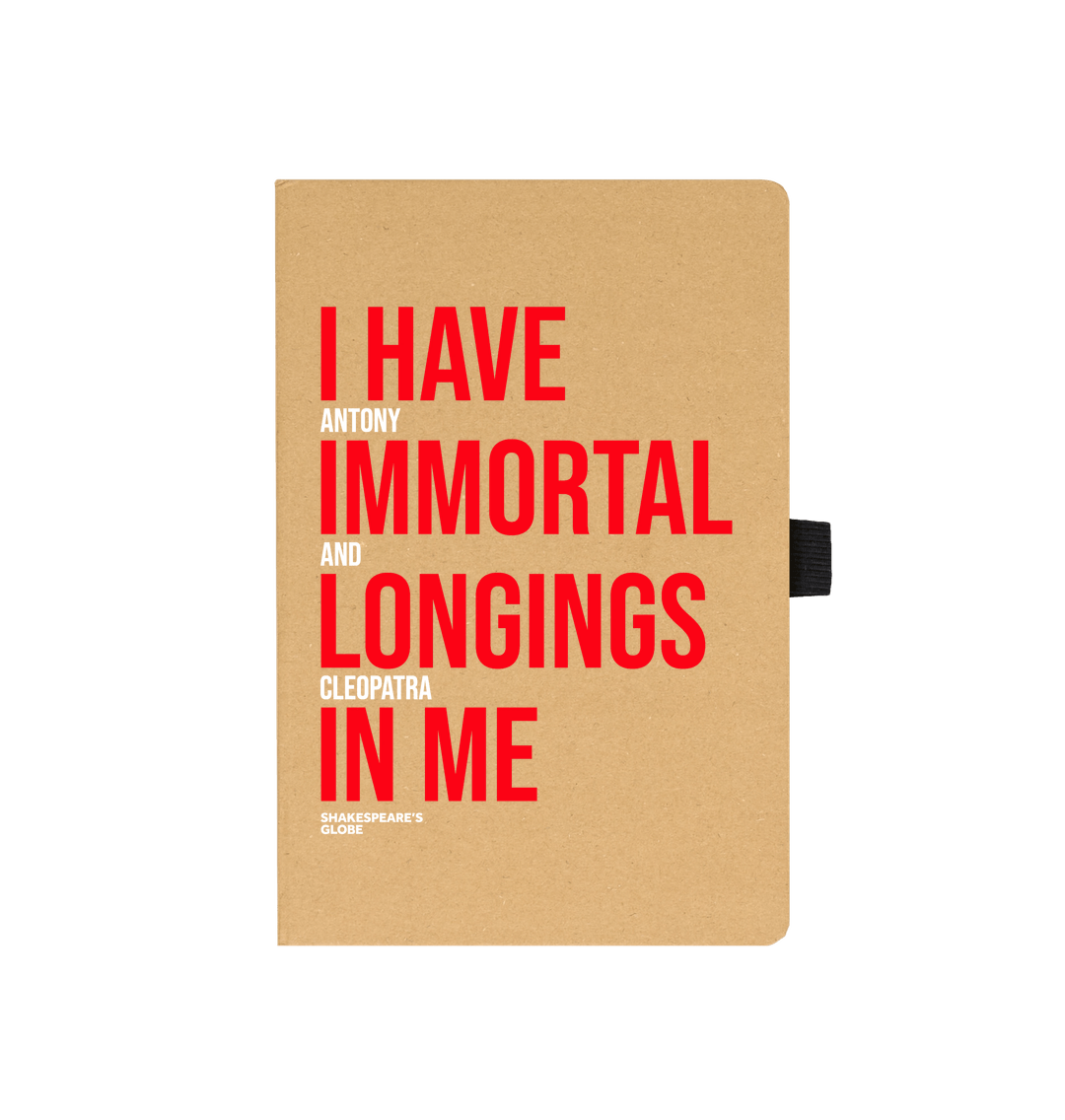 Kraft notebook with red and white graphic text on the front, with black elastic closure