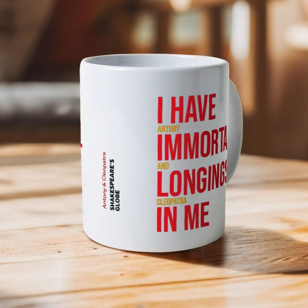 White mug with red and yellow block graphic text on either side