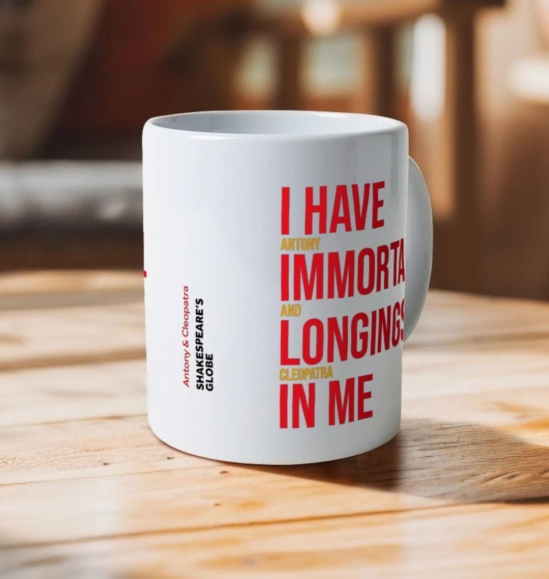 White mug with red and yellow block graphic text on either side