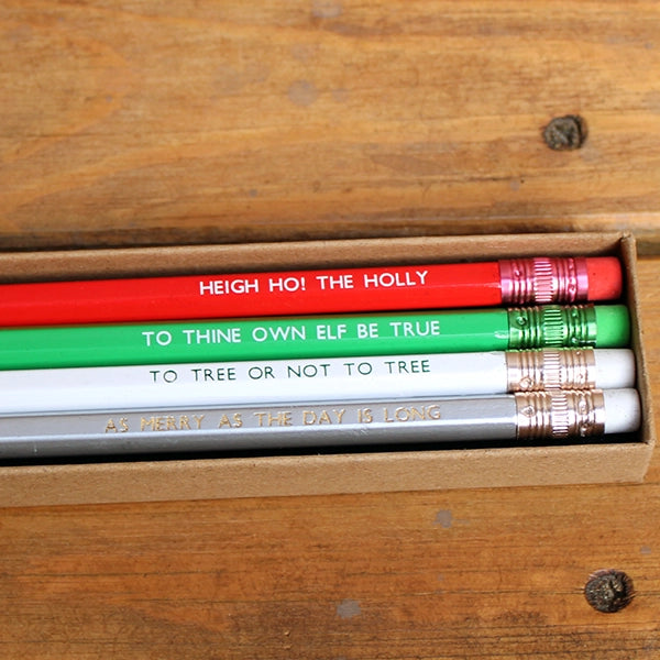 Natural card box with four pencils, from top to bottom, red, green, white, silver, all featuring a Christmas themed Shakespearean quote