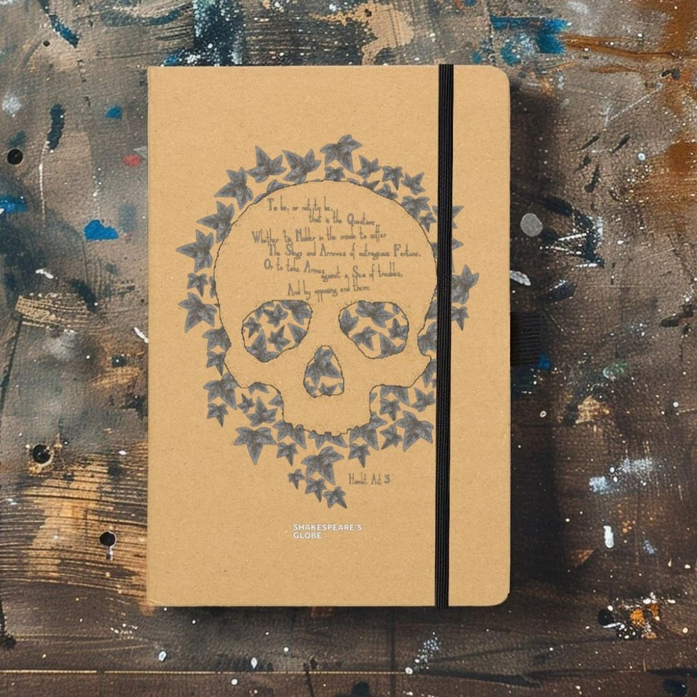 Kraft notebook with leaf skull motif graphic in grey on centre front, with black elastic closure on left side