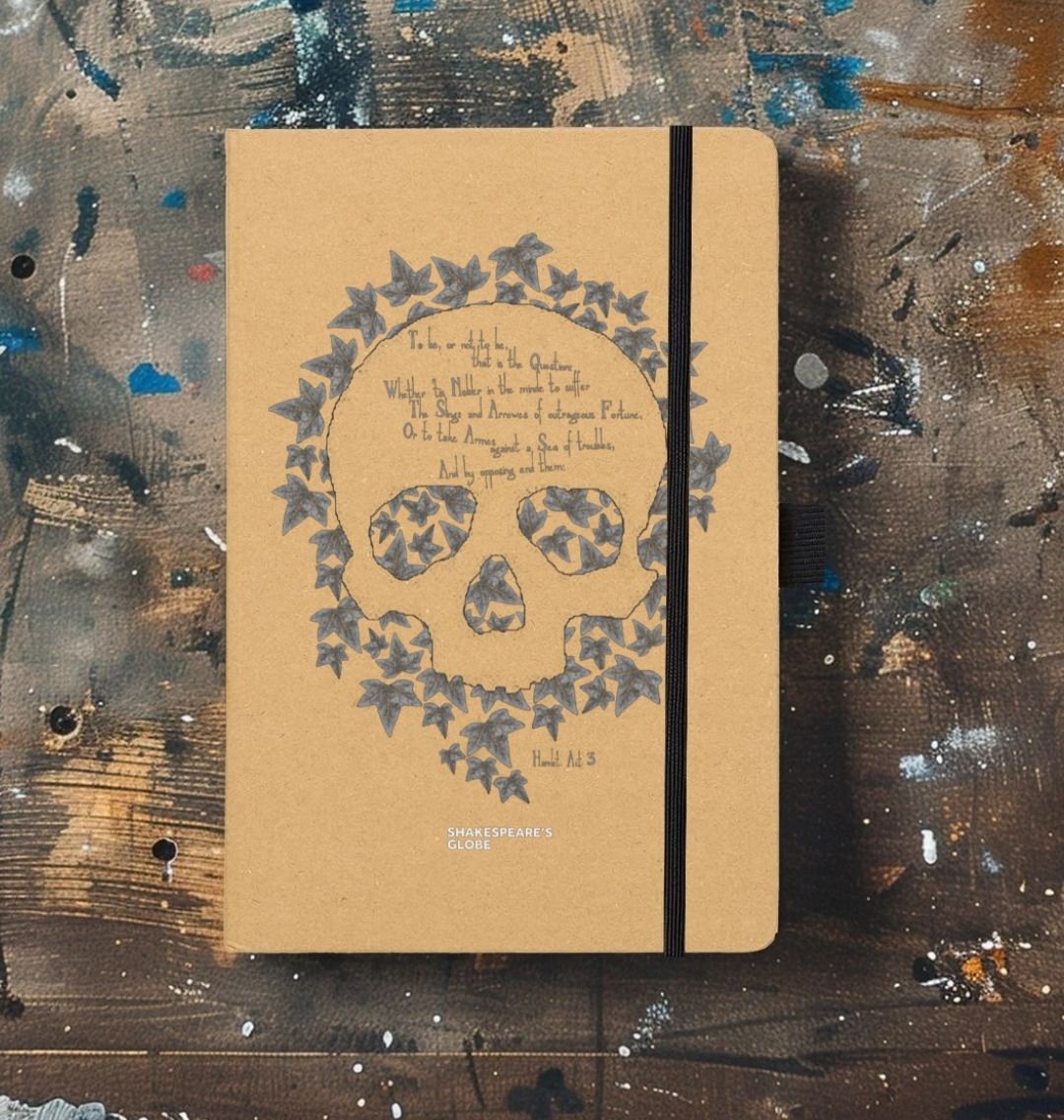 Kraft notebook with leaf skull motif graphic in grey on centre front, with black elastic closure on left side