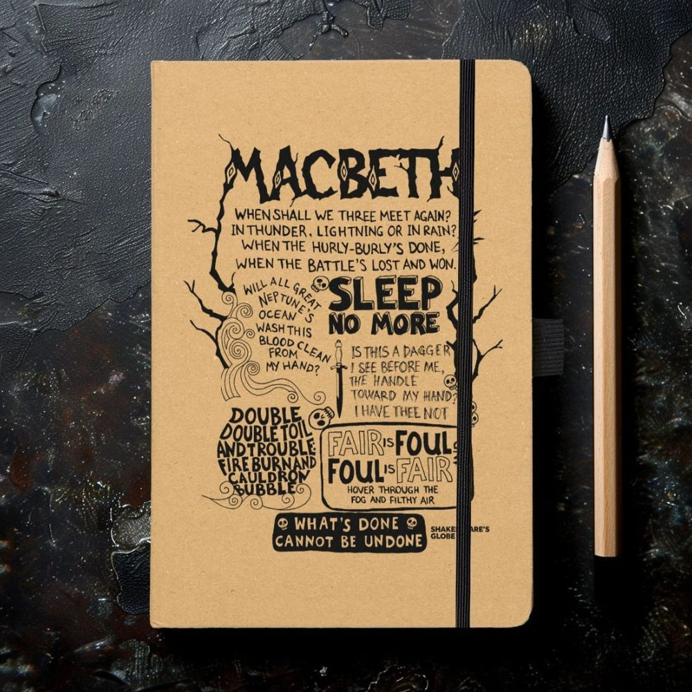 Kraft notebook with black graphic text quotes depicting Macbeth, with elastic closure on left hand side and on black mottled background with sharpened pencil