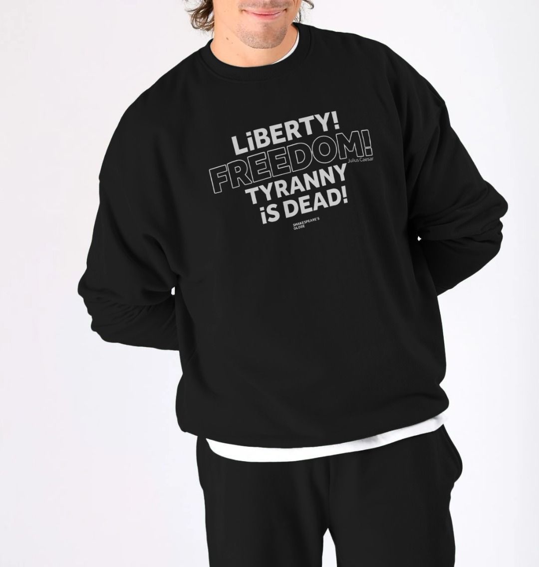 Black oversized fit men's sweatshirt with centre front graphic text in white colour, all letters filled in except for the word Freedom which is outlined in white only