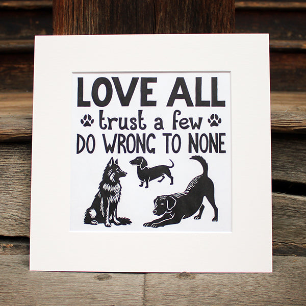 Print with black text and dog illustrations on a wooden surface