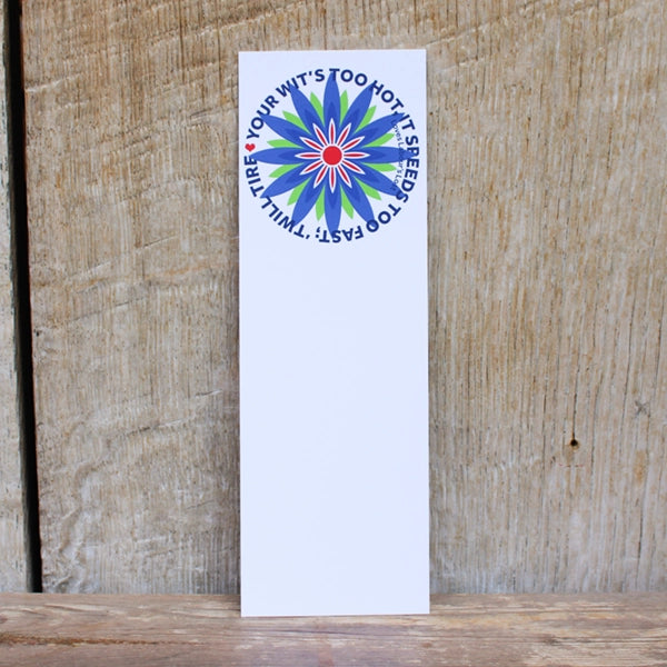 large white bookmark with a blue flower design on a wooden background