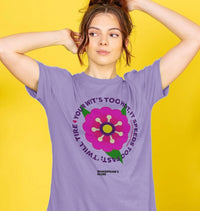 Person wearing a purple t-shirt with a colorful flower graphic and text on a yellow background