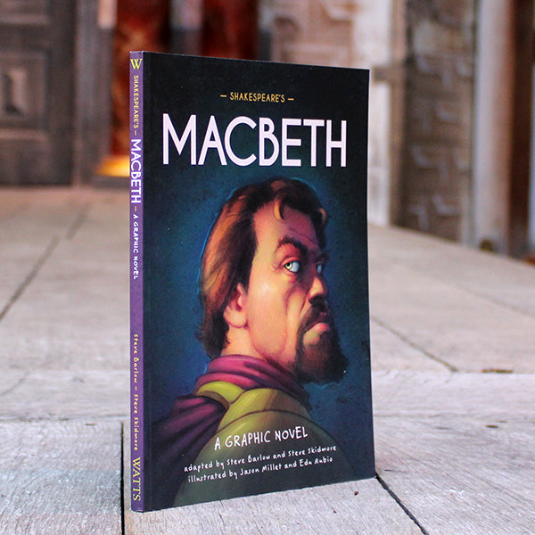Paperback book with steely blue cover featuring cartoon depiction of Macbeth and white text