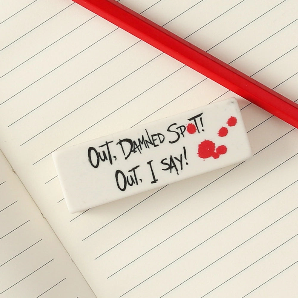 White eraser with black text and red pencil on open notebookRed pencil with red eraser and white stamped text with white eraser on open lined notebook