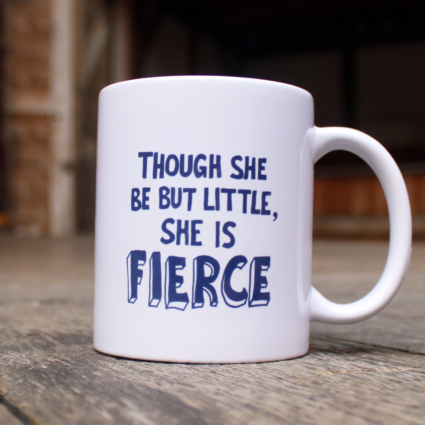 White mug with dark blue stylised 'fierce' quote graphics on either side