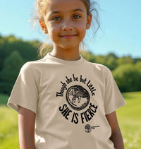 Young girl wearing a t-shirt with 'She is Fierce' design outdoors