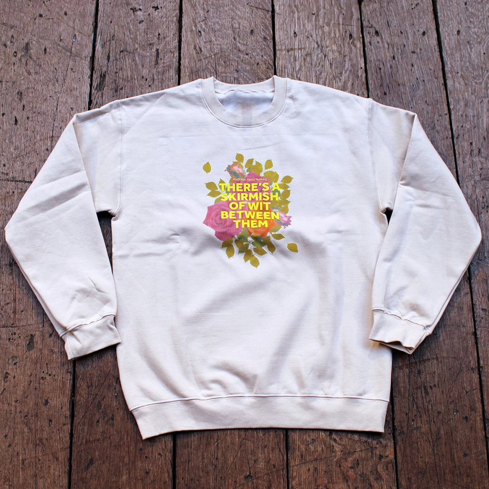 Sand coloured sweatshirt with pixelated image of roses with yellow graphic text overlayed