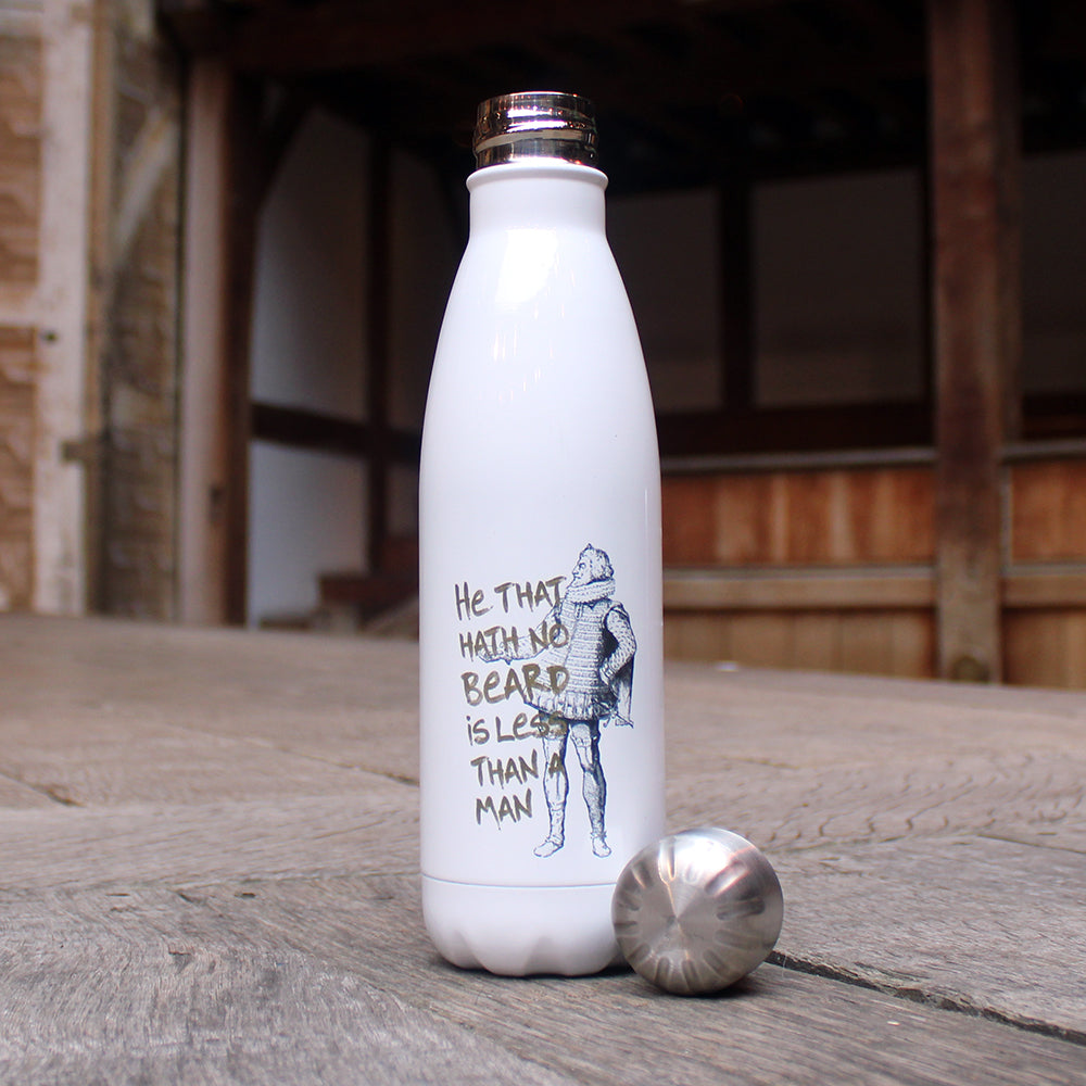 white metal water bottle with a silver lid and a black and green print, sitting on wooden stage