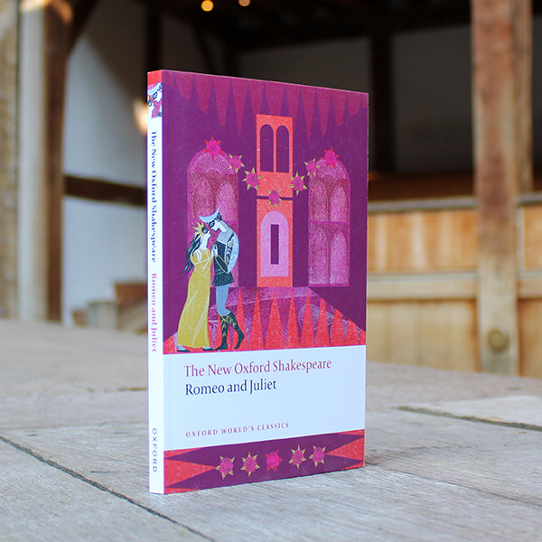 Purple paperback book with cartoon Romeo and Juliet on the cover