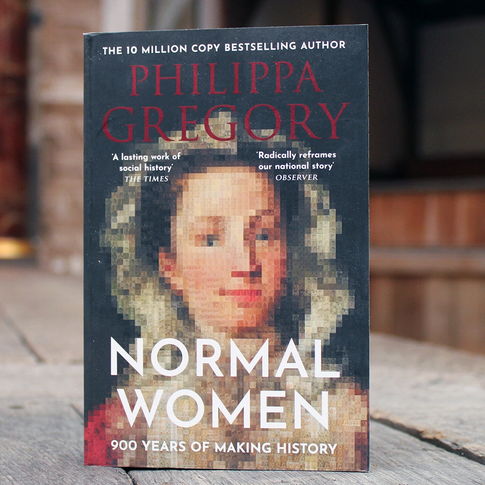 Black paperback book with red and white writing, featuring image of pixelated woman