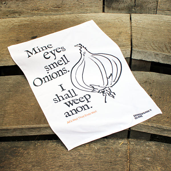 white tea towel with black text and an illustration of an onion print