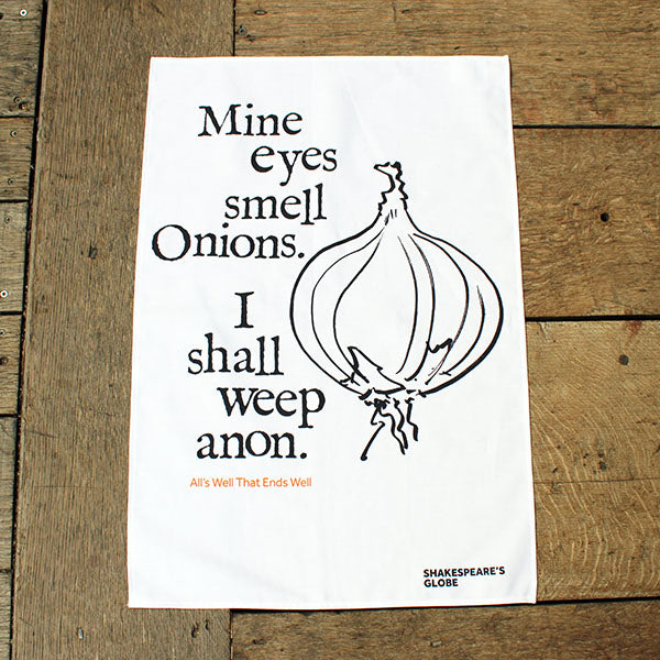 white tea towel with black text and an illustration of an onion print
