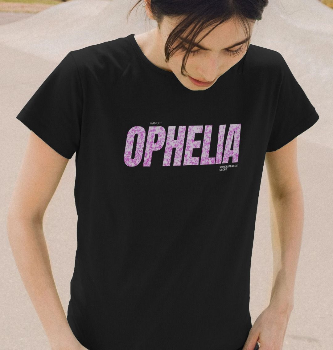 Person wearing a black t-shirt with 'OPHELIA' printed in pink on a neutral background