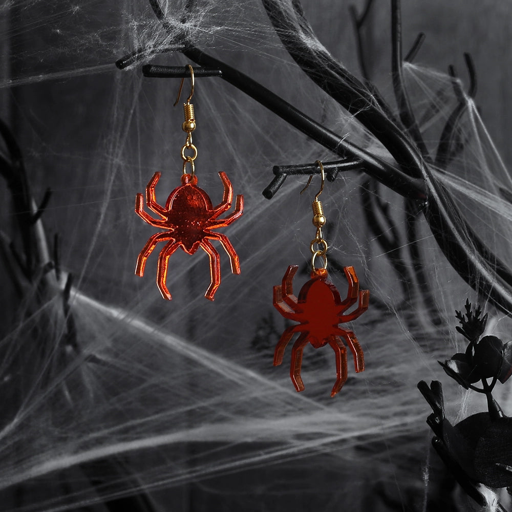 Perspex acrylic drop earring shaped like spiders. The spiders are made from mirror acrylic in orange and have gold coloured metal fixings.