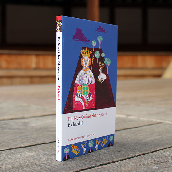 paperback book with a blue and purple cover sitting on a wooden surface
