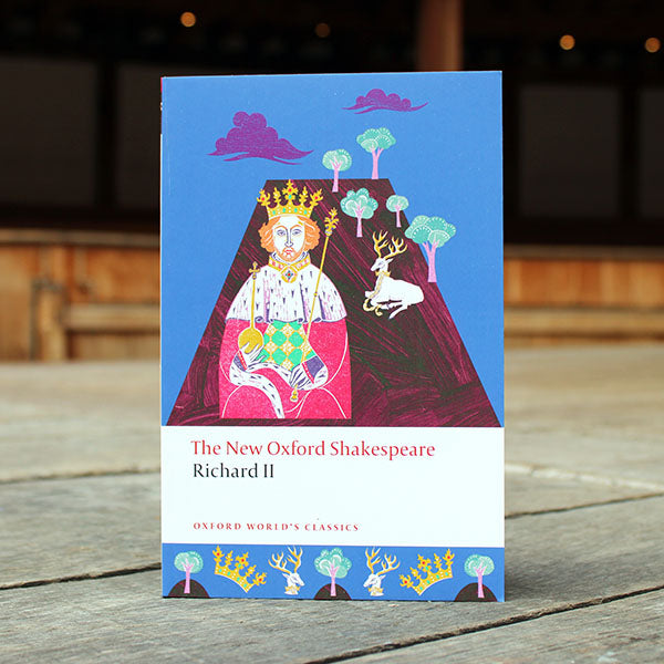paperback book with a blue and purple cover sitting on a wooden surface