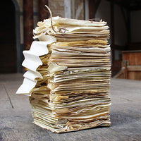 Stack of aged papers on a wooden surface