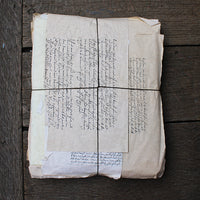 Old document with handwritten text on a wooden surface