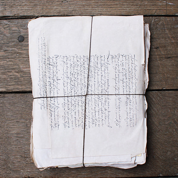 Folded paper with handwritten text on a wooden surface