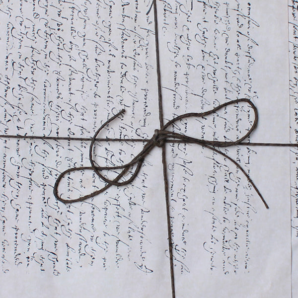 papers with text tied with string
