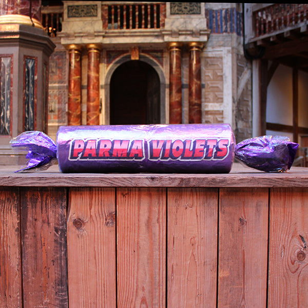 Parma Violets sweet prop on a wooden surface 