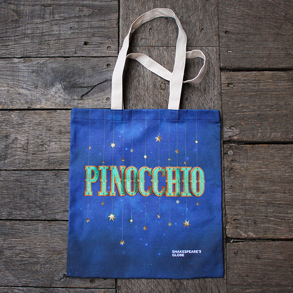 Blue tote bag with 'Pinocchio' text on a wooden surface