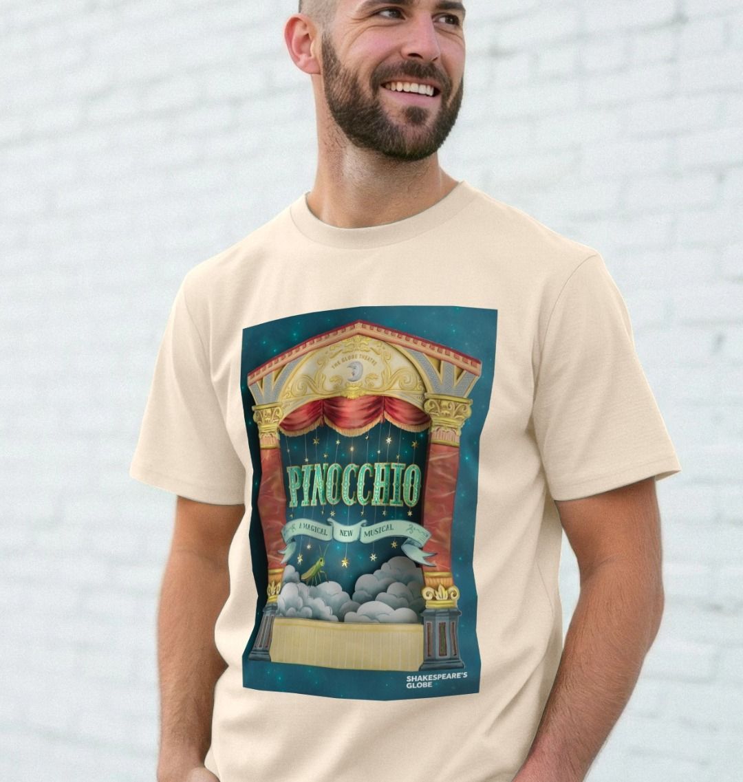 Man wearing a t-shirt with a Pinocchio graphic design against a light gray brick wall.