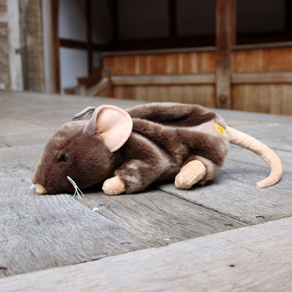 
                  
                    Sandy brown soft toy rat with white whiskers and beige inner ears, feet, nose and tail on wooden stage
                  
                
