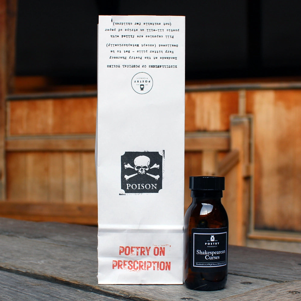 
                      
                        Brown pill bottle with black lid and black label with white writing on it, filled with multicoloured pill poems, sitting next to white paper medicine back with skull and cross bones label
                      
                    