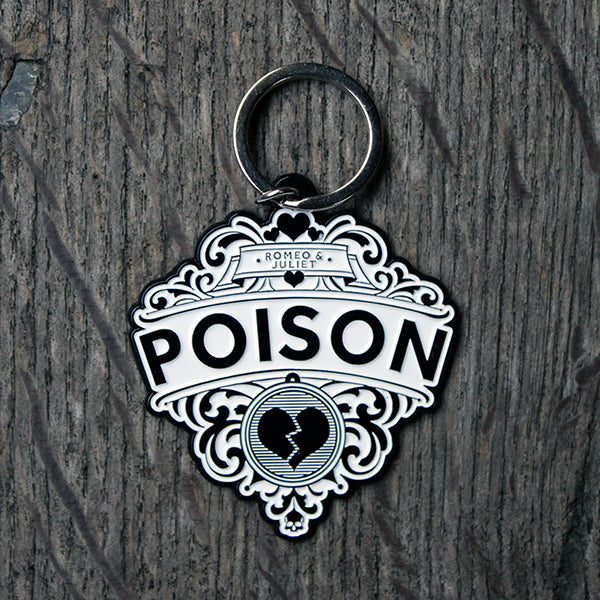 Black and white keyring on silver metal base, with black writing and black heart and skull motif