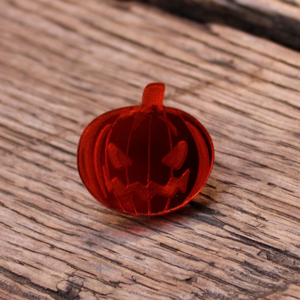 
                      
                        Orange plastic pumpkin pin with etched Jack o'Lantern face in the centre
                      
                    