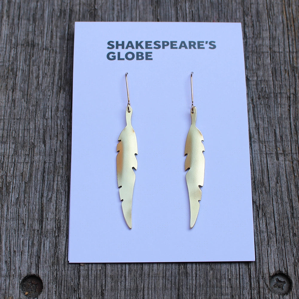 
                      
                        Two brass feather quill earrings on white branded backing card
                      
                    