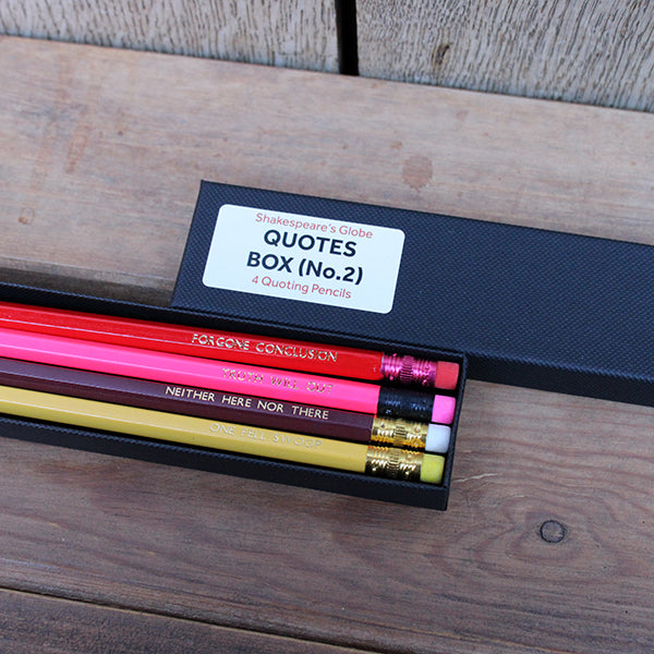 Black card box with white sticker, with 4 pencils, maroon, yellow, red and pink, stamped with text