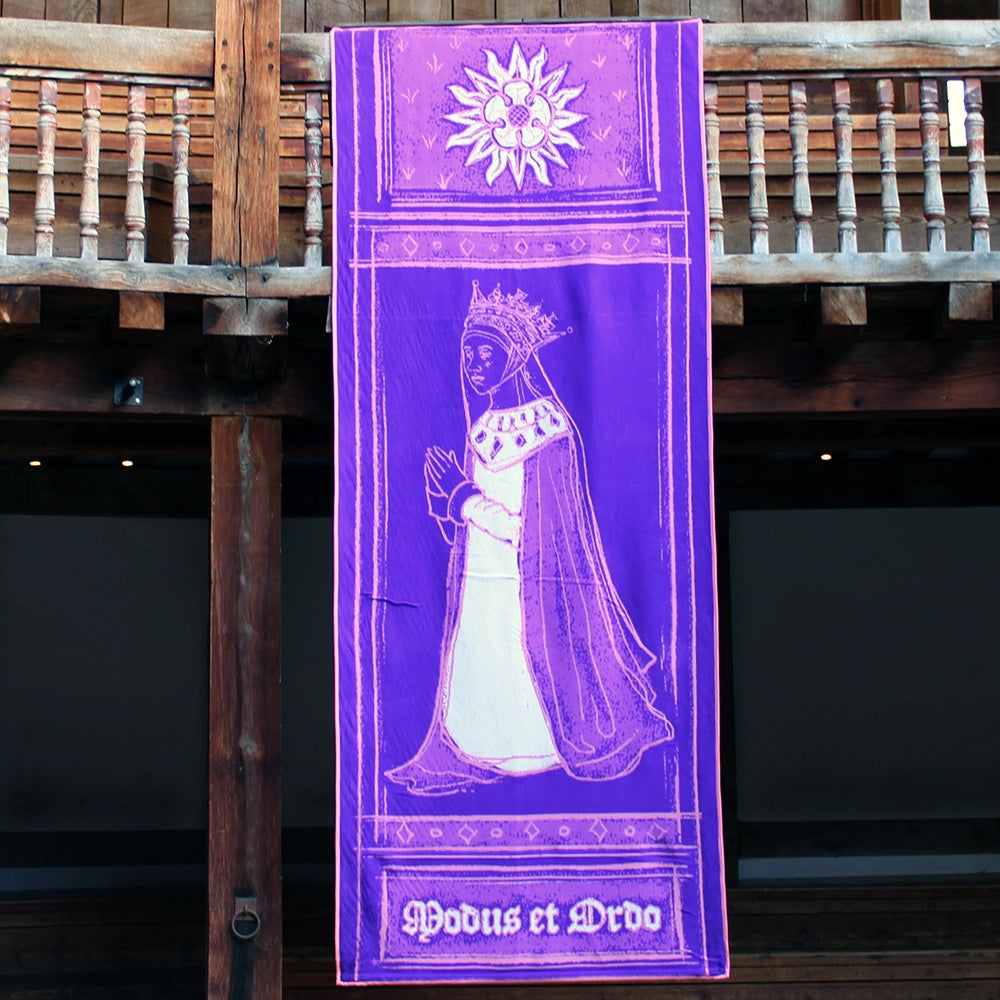 Deep purple banner with white and pink graphics, hanging from wooden rafters