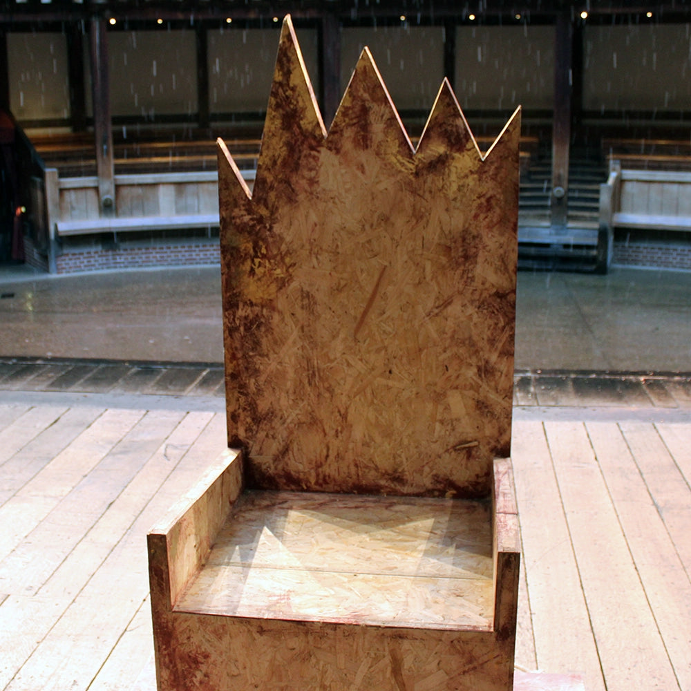 
                  
                    Chipboard throne from Richard III production at Shakespeare's Globe 2024, throne has jagged cut top and is mounted on chipboard base
                  
                