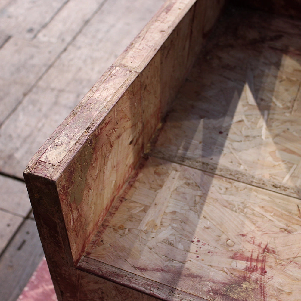 
                  
                    Chipboard throne from Richard III production at Shakespeare's Globe 2024, throne has jagged cut top and is mounted on chipboard base
                  
                