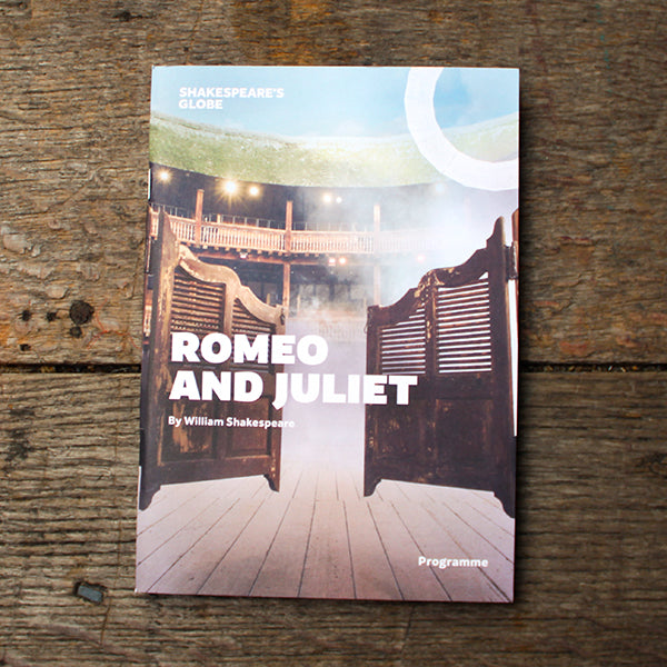theatre programme for 'Romeo and Juliet' by William Shakespeare on a wooden surface