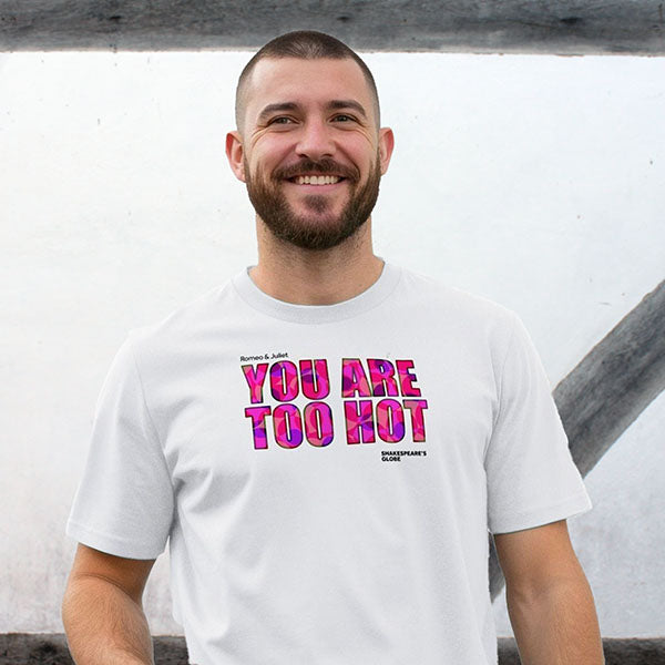 Man wearing a white t-shirt with colourful text against a plain background